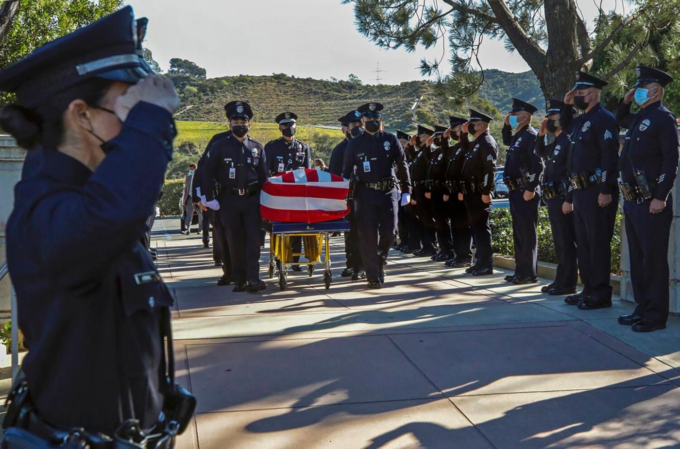 Dozens arrested in raids targeting gang linked to LAPD officer’s killing while he was house hunting