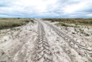 high angle shot country road covered snow wintertime