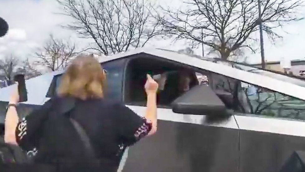 protester argues with cybertruck owner